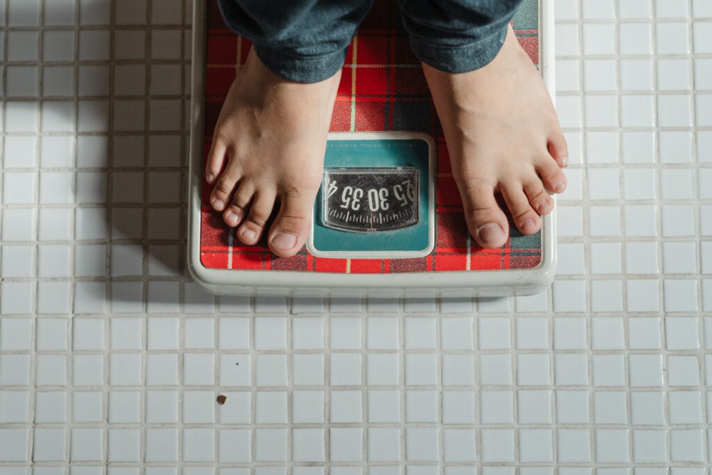 Two bare feet standing on a weigh scale